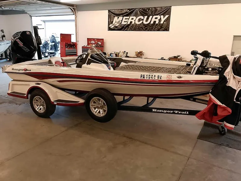 The Image of 2021 Ranger Z519 SC fishing boat in garage, on trailer, with Mercury banner. - 1