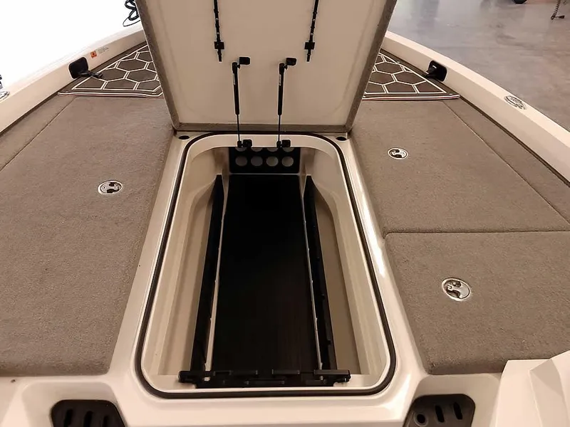Slide: The Image of 2021 Ranger Z519 SC boat with open storage compartment, gray carpeted deck. - 16