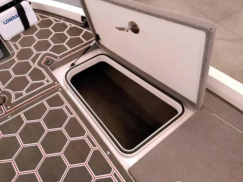 Slide: The Image of 2021 Ranger Z519 SC boat storage compartment with hexagonal patterned flooring. - 18