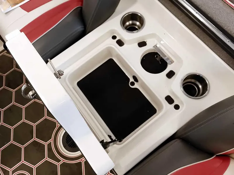 Slide: The Image of 2021 Ranger Z519 SC boat interior with storage compartment and cup holders. - 26