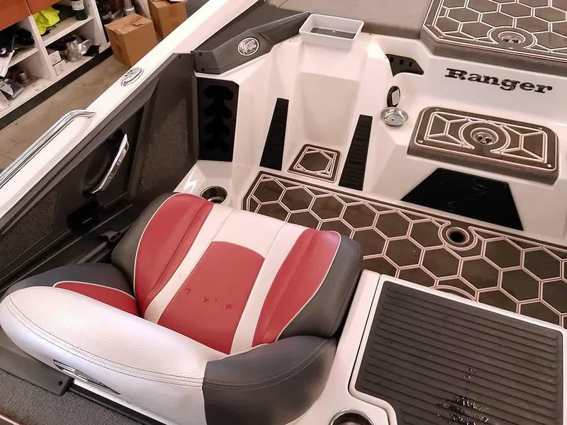 Slide: The Image of 2021 Ranger Z519 SC boat interior with red and white seat, hexagonal flooring, and storage compartments. - 27