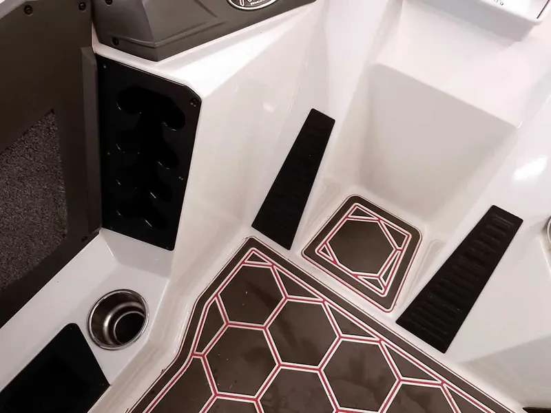 Slide: The Image of 2021 Ranger Z519 SC boat interior with geometric floor design and storage compartments. - 28