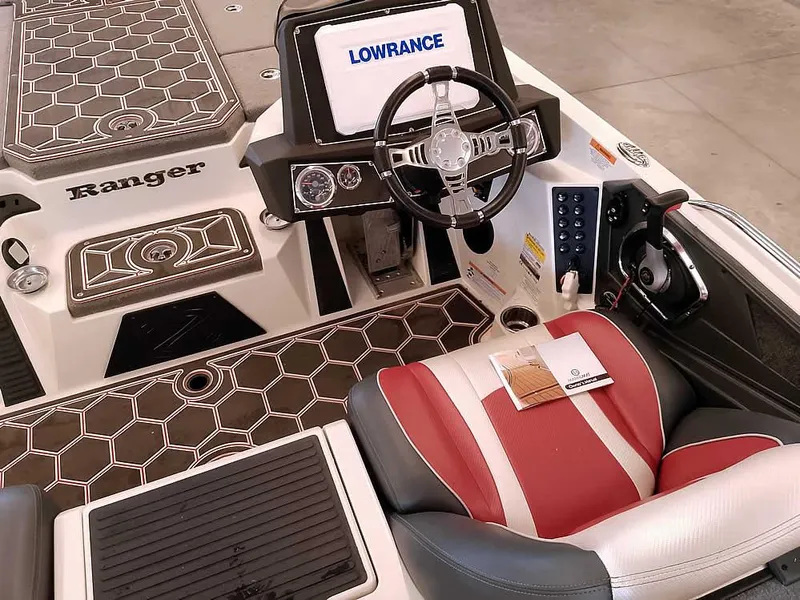 Slide: The Image of 2021 Ranger Z519 SC boat interior with Lowrance system and stylish red and white seating. - 30
