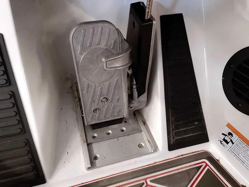 Slide: The Image of Foot pedal controls in a 2021 Ranger Z519 SC boat cockpit. - 31
