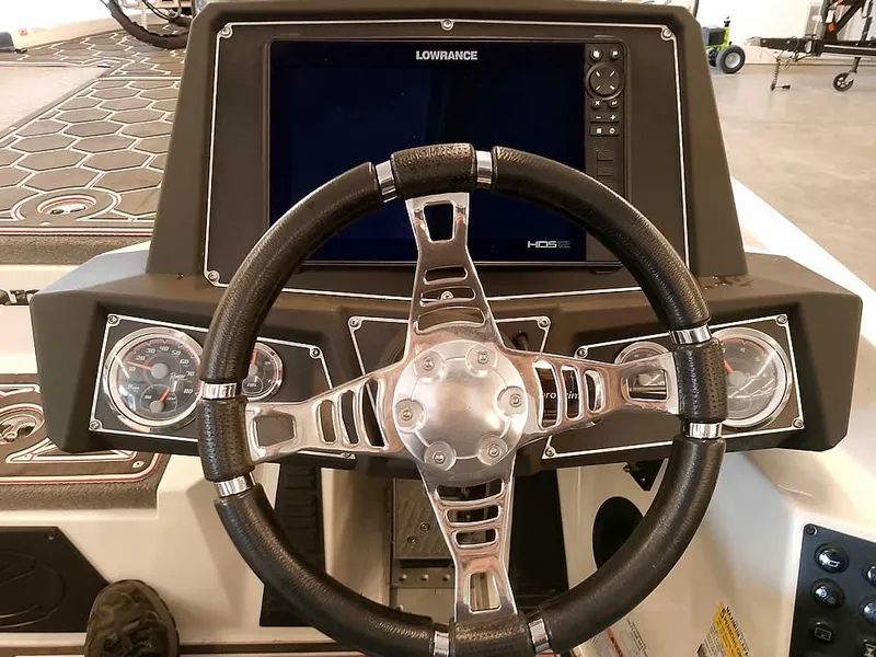 Slide: The Image of 2021 Ranger Z519 SC boat dashboard with Lowrance display and steering wheel. - 32