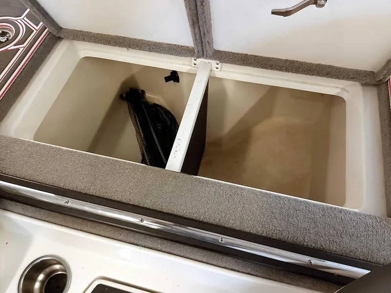 Slide: The Image of 2021 Ranger Z519 SC boat storage compartment with open lid and interior view. - 34