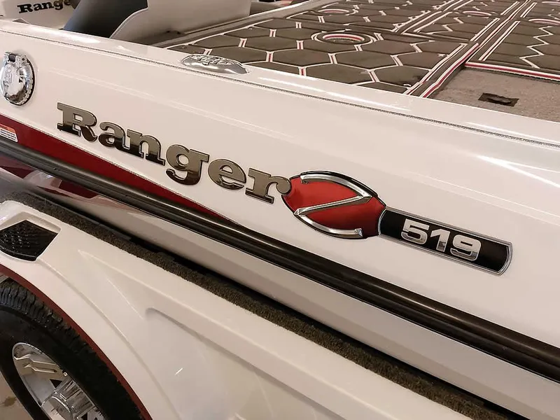 Slide: The Image of 2021 Ranger Z519 SC boat, white with red accents, close-up of logo and deck. - 4