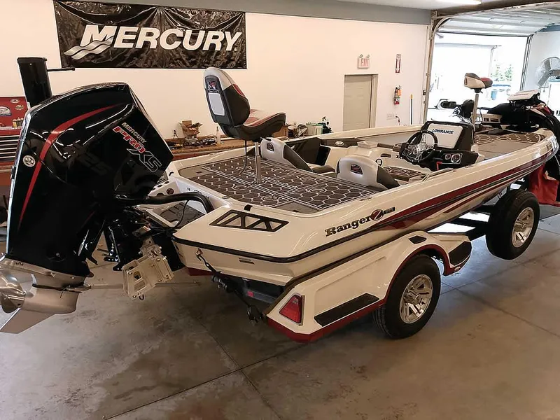 Slide: The Image of 2021 Ranger Z519 SC boat in garage, featuring Mercury engine and trailer. - 41