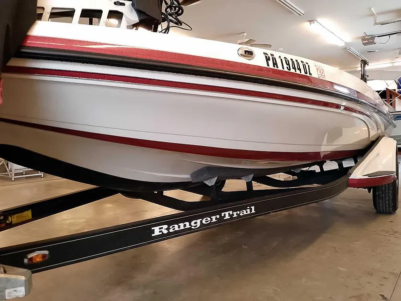Slide: The Image of 2021 Ranger Z519 SC boat on trailer in a garage setting. - 7