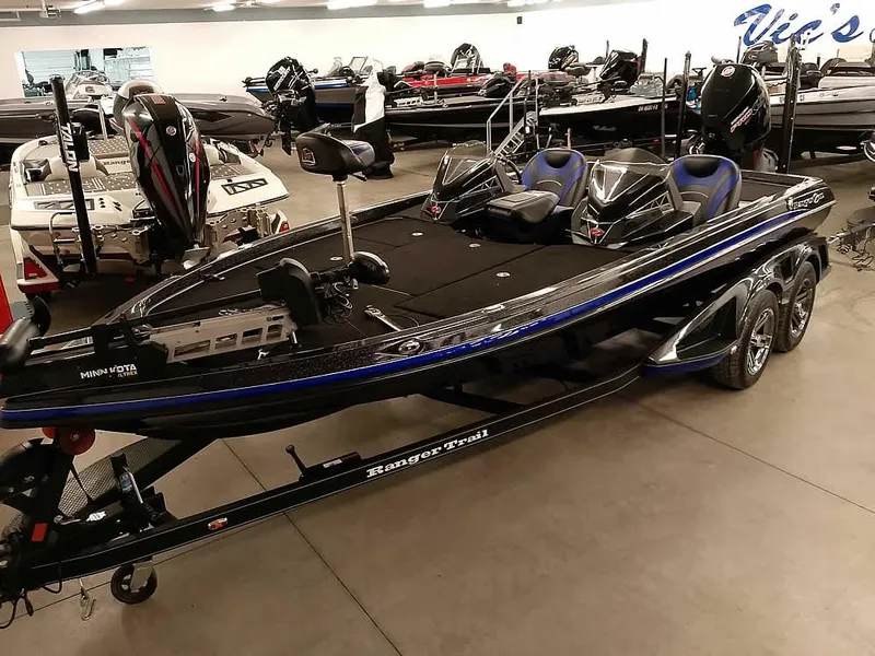 The Image of 2020 Ranger Z520L Comanche DC boat in showroom, sleek black design with blue accents. - 1