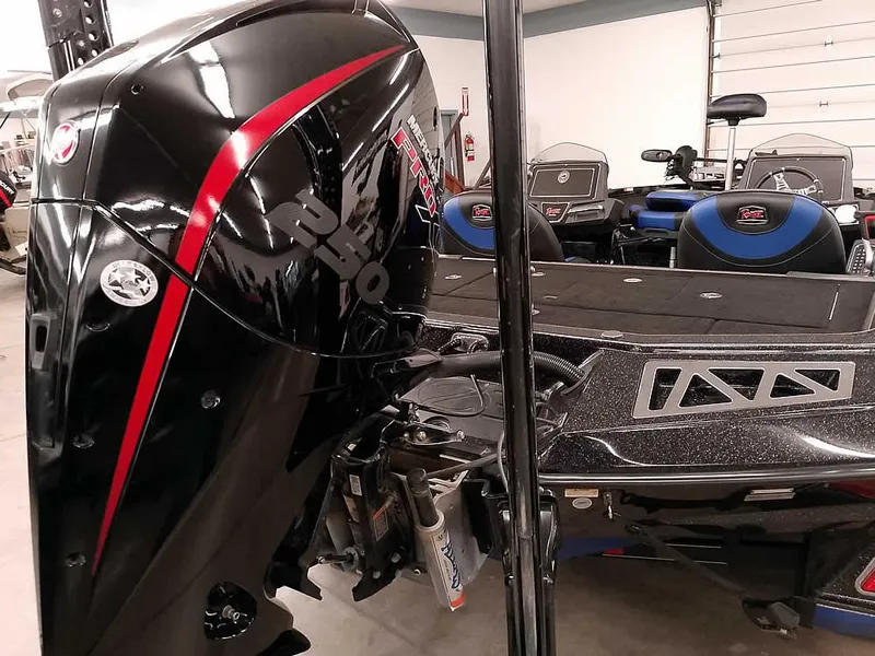Slide: The Image of 2020 Ranger Z520L Comanche DC boat with powerful black and red motor in a showroom. - 2