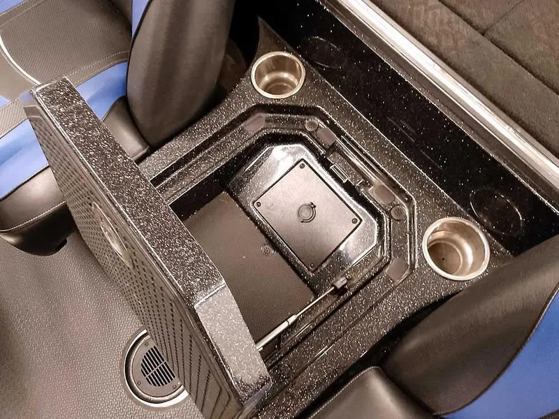 Slide: The Image of 2020 Ranger Z520L Comanche DC boat interior with storage compartment and cup holders. - 23