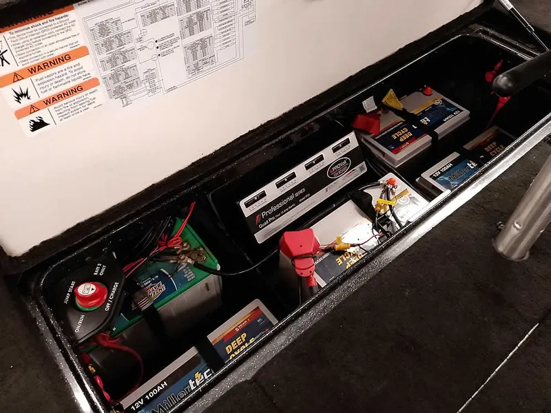 Slide: The Image of Battery compartment of 2020 Ranger Z520L Comanche DC boat, showing multiple batteries and wiring. - 33