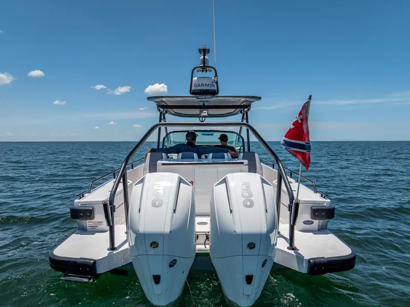 Slide: The Image of 2022 Axopar 28 T-Top Brabus on open water, rear view with dual engines. - 10