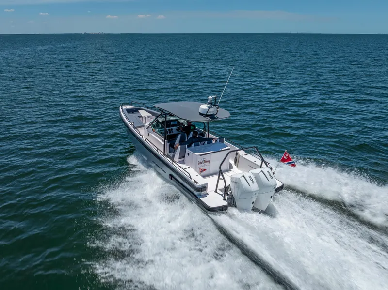 Slide: The Image of 2022 Axopar 28 T-Top Brabus cruising on open water, rear view. - 11