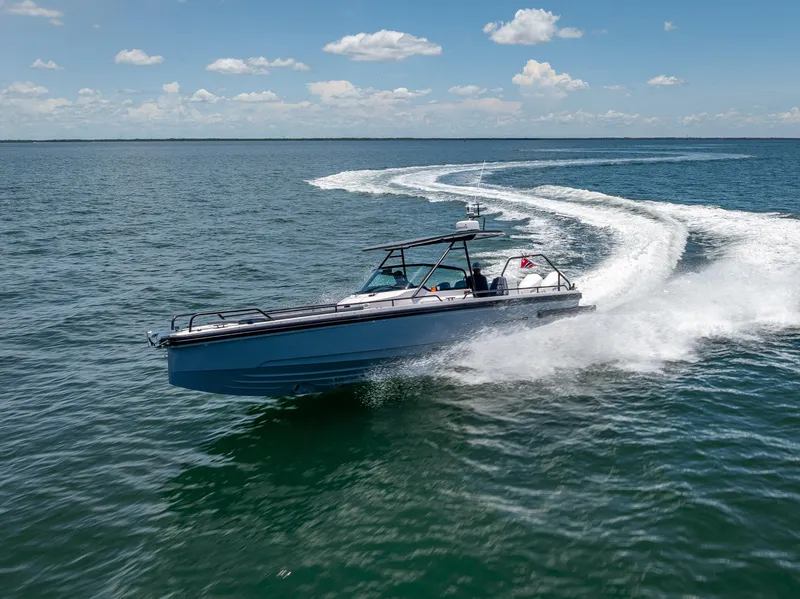 Slide: The Image of 2022 Axopar 28 T-Top Brabus speeding on open water under clear skies. - 20