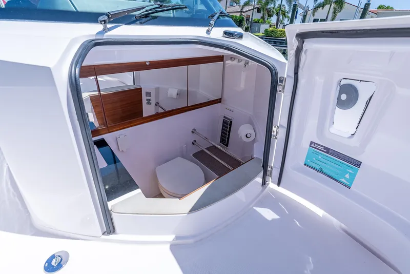 Slide: The Image of Interior view of 2022 Axopar 28 T-Top Brabus boat's compact bathroom. - 23