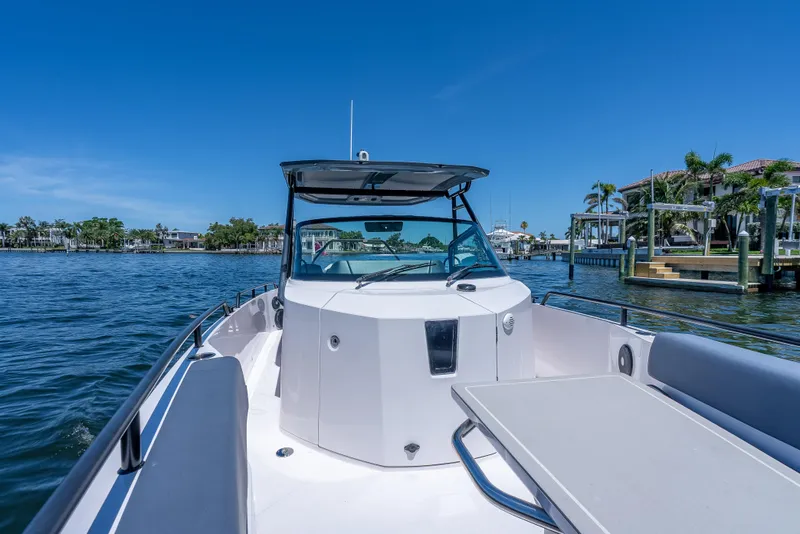 Slide: The Image of 2022 Axopar 28 T-Top Brabus on water, showcasing sleek design and spacious deck. - 25