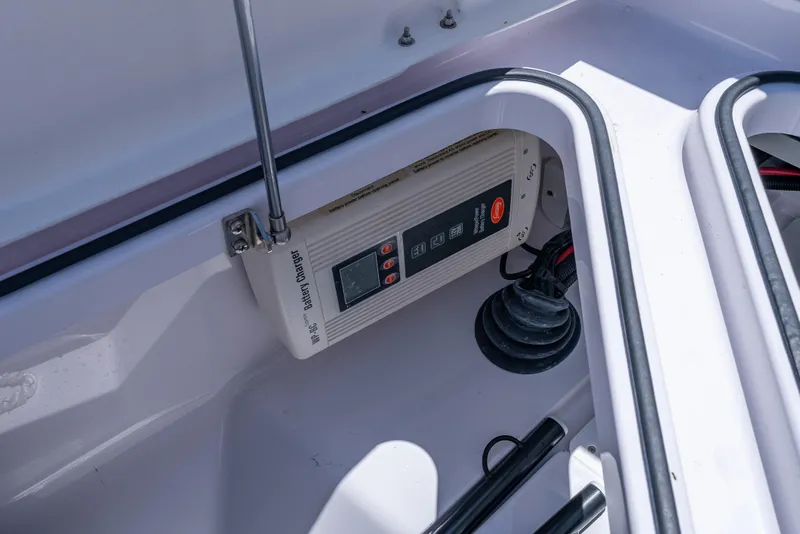 Slide: The Image of Battery charger in 2022 Axopar 28 T-Top Brabus boat compartment. - 27