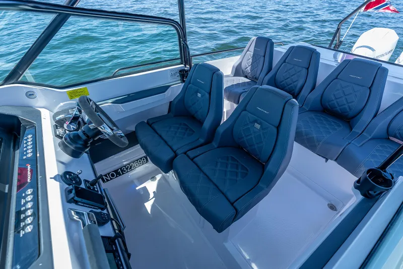 Slide: The Image of 2022 Axopar 28 T-Top Brabus interior with luxury seating and steering wheel. - 29