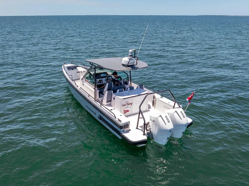 Slide: The Image of 2022 Axopar 28 T-Top Brabus boat cruising on open water. - 3