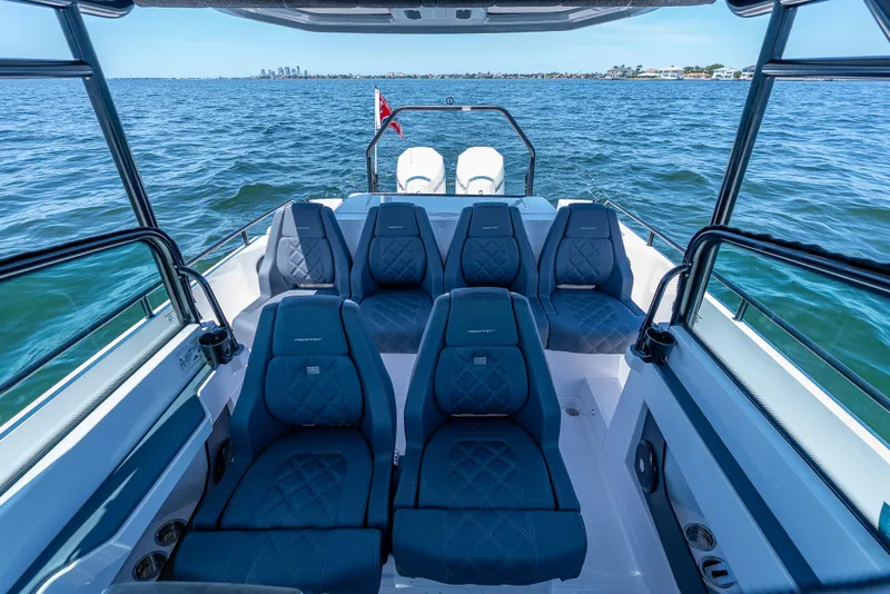 Slide: The Image of 2022 Axopar 28 T-Top Brabus boat interior with blue seating on open water. - 30