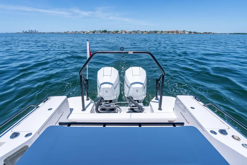 Slide: The Image of Axopar 28 T-Top Brabus 2022 boat with dual engines on open water. - 36