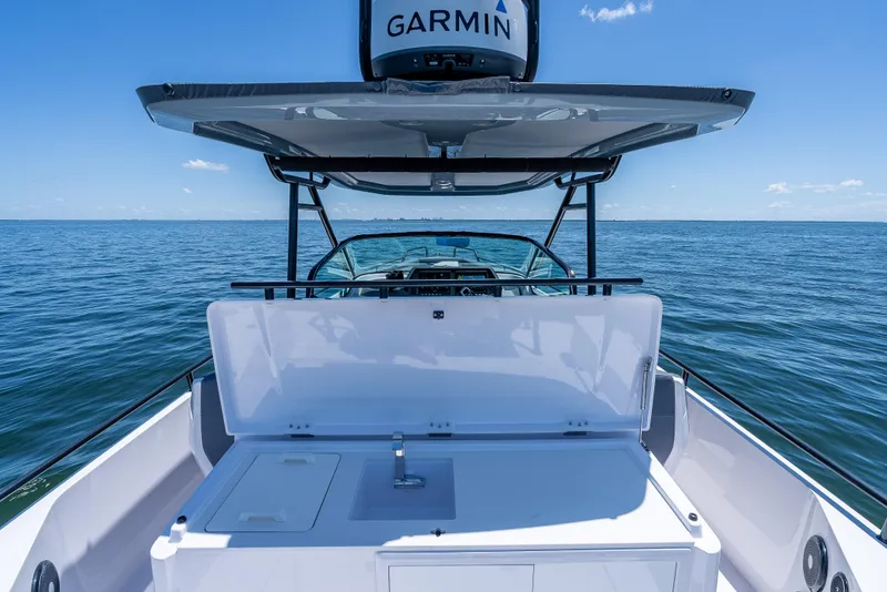 Slide: The Image of 2022 Axopar 28 T-Top Brabus boat on open water, featuring Garmin equipment. - 37