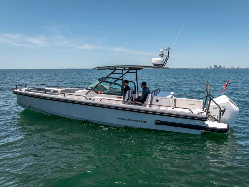 Slide: The Image of 2022 Axopar 28 T-Top Brabus boat cruising on open water. - 4