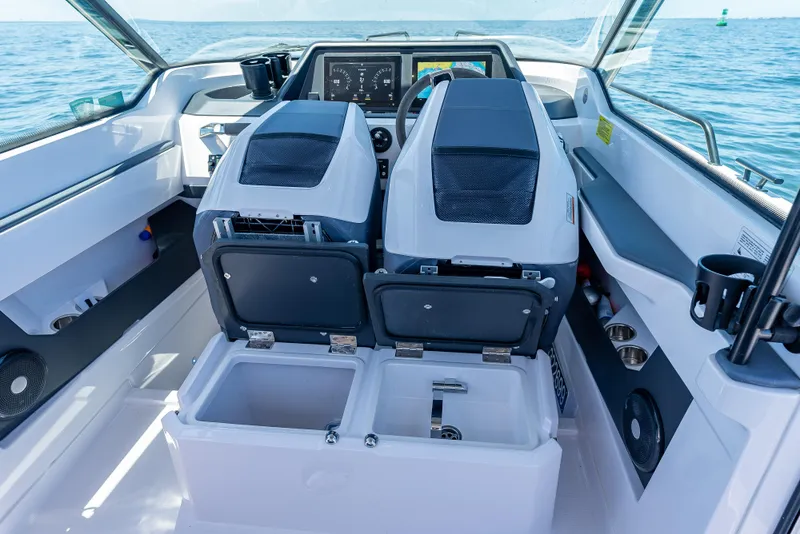 Slide: The Image of 2022 Axopar 28 T-Top Brabus boat interior with dual seats and dashboard view. - 40