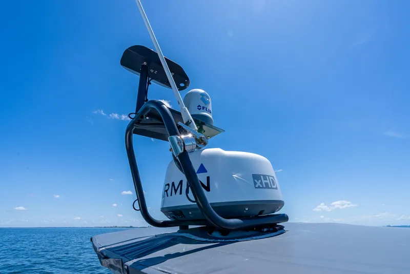 Slide: The Image of Radar equipment on 2022 Axopar 28 T-Top Brabus under clear blue sky. - 41