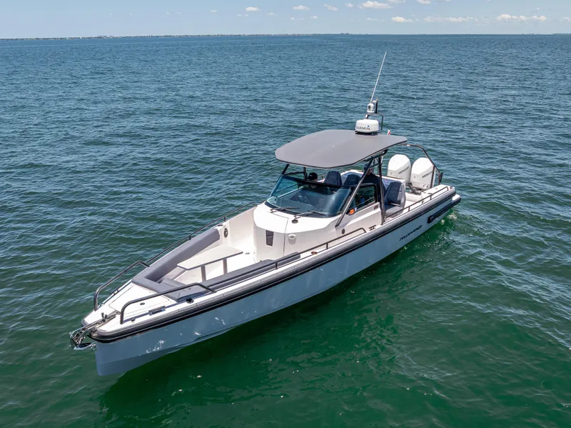 Slide: The Image of 2022 Axopar 28 T-Top Brabus boat cruising on open water. - 6