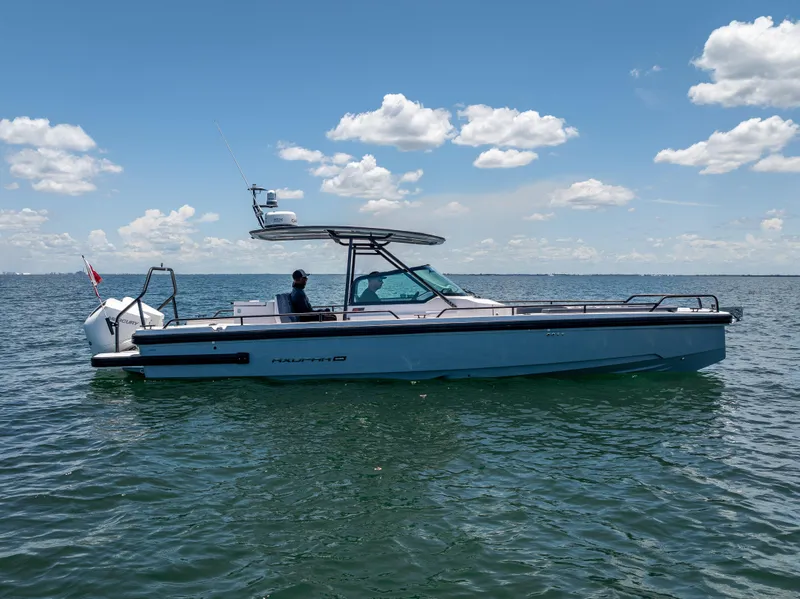 Slide: The Image of 2022 Axopar 28 T-Top Brabus boat on open water under blue sky. - 8