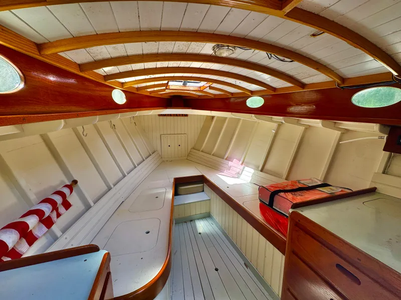 Slide: The Image of Interior of 2008 Custom Eldred Cooper 30 Downeast boat, featuring wooden finishes and seating. - 12