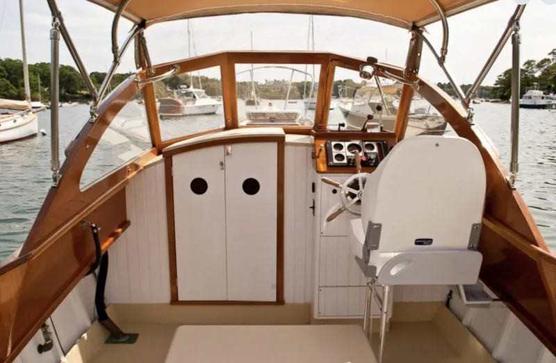 Slide: The Image of 2008 Custom Eldred Cooper 30 Downeast boat interior with helm and wooden accents. - 27