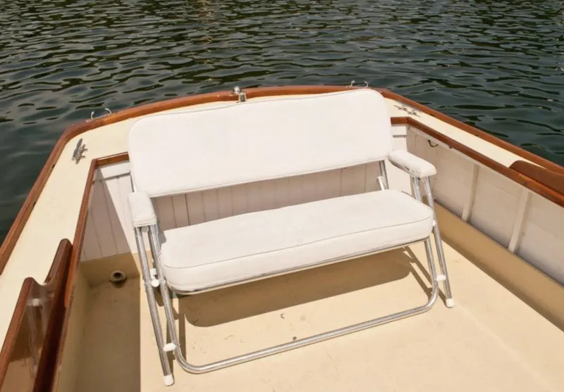 Slide: The Image of White cushioned bench on 2008 Eldred Cooper 30 Downeast boat, near water. - 28