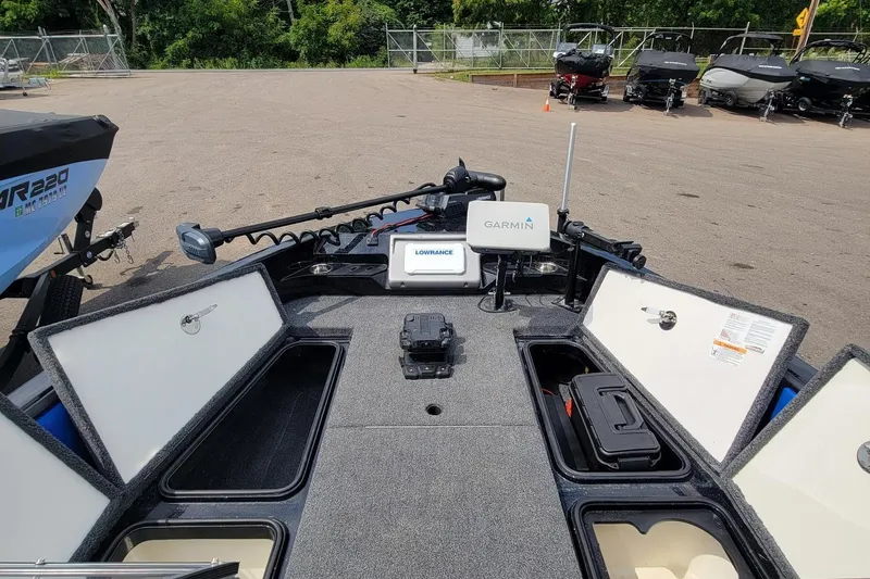 Slide: The Image of 2025 Ranger 2080 Angler boat interior with Garmin and Lowrance equipment, open storage compartments. - 12