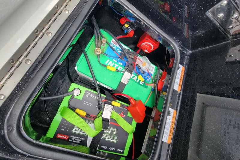 Slide: The Image of Battery compartment of 2025 Ranger 2080 Angler boat with wiring and connections. - 16