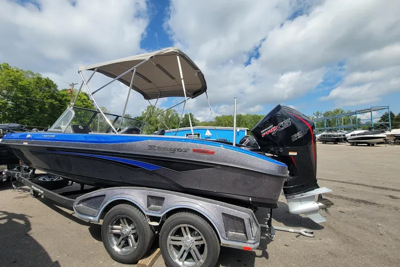 Slide: The Image of 2025 Ranger 2080 Angler boat with canopy and powerful outboard motor on trailer. - 18