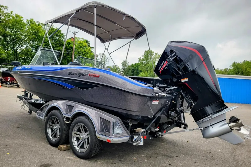The Image of 2025 Ranger 2080 Angler boat with canopy and powerful outboard motor on trailer. - 4