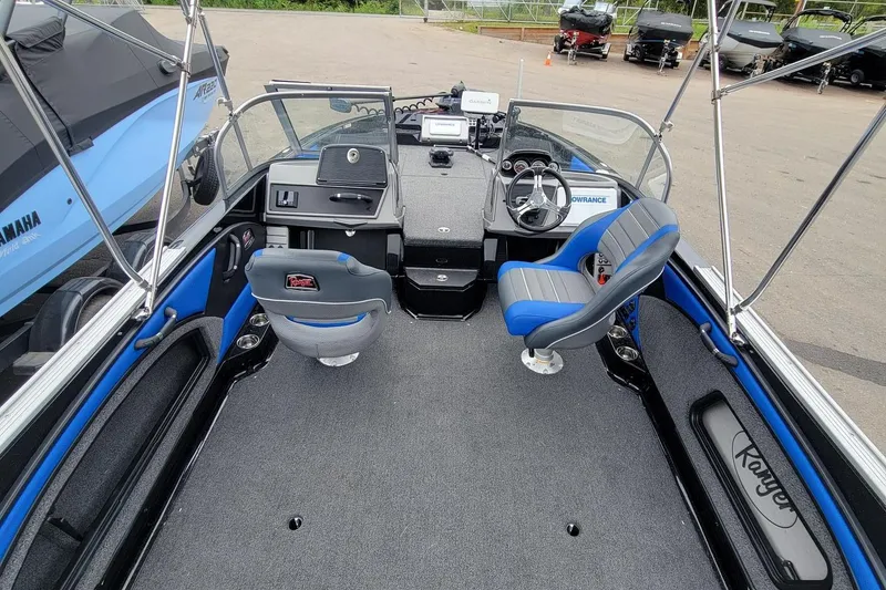 Slide: The Image of 2025 Ranger 2080 Angler boat interior with blue and gray seating, steering console, and equipment. - 8