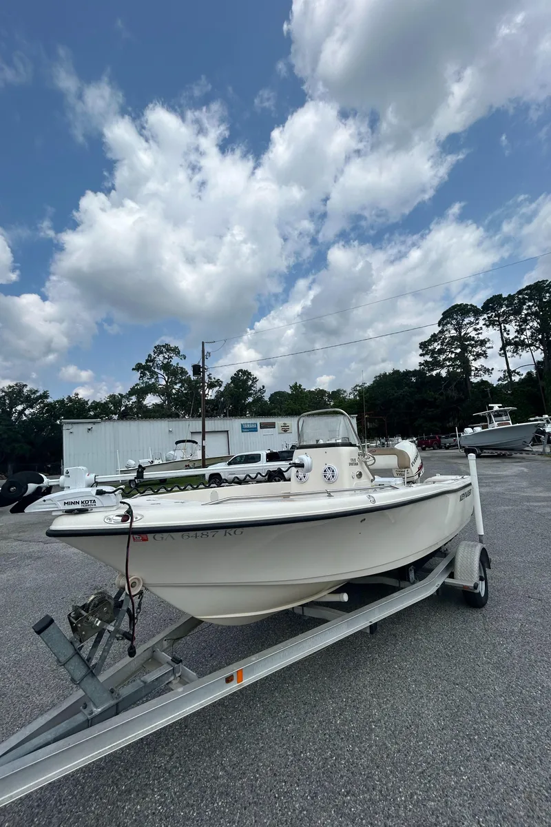 Slide: The Image of 2006 Key West 176 CC SPORTSMAN boat on trailer under cloudy sky. - 2