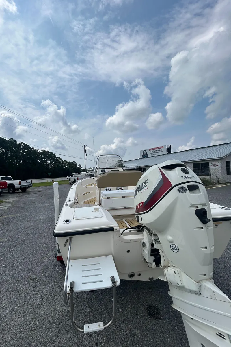 Slide: The Image of 2006 Key West 176 CC Sportsman boat with outboard motor, parked outdoors under cloudy sky. - 4