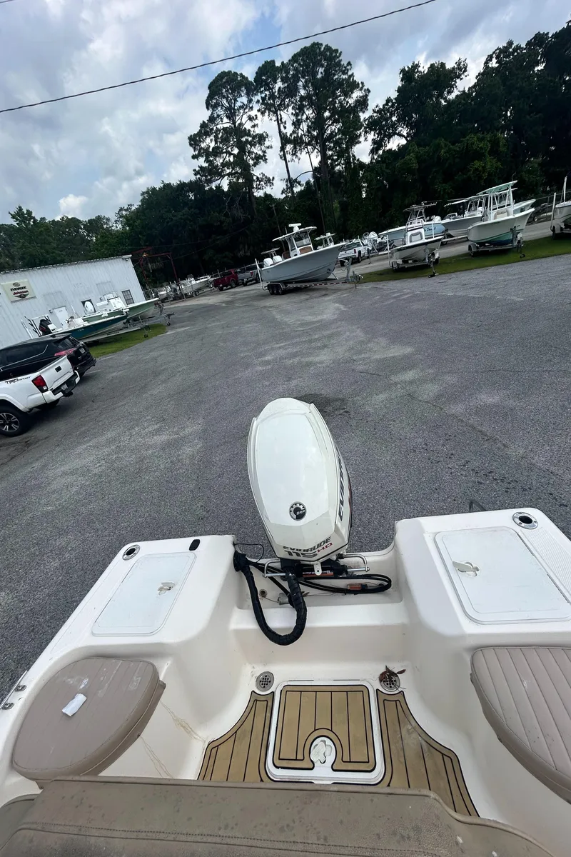 Slide: The Image of 2006 Key West 176 CC Sportsman boat with outboard motor in a parking lot. - 5