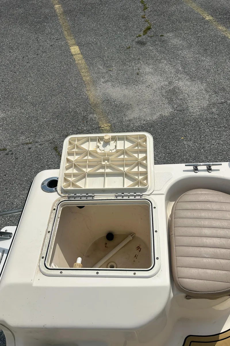 Slide: The Image of 2006 Key West 176 CC SPORTSMAN boat with open storage compartment and cushioned seat. - 6
