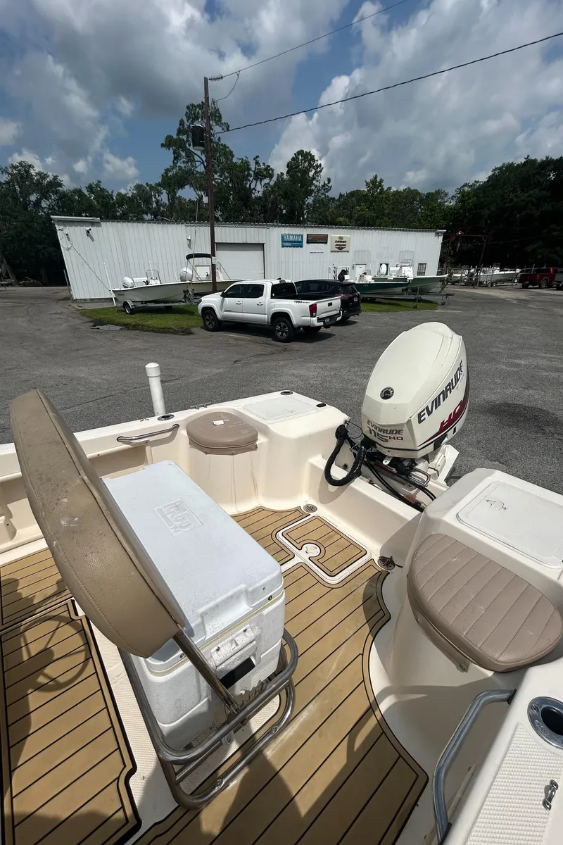 Slide: The Image of 2006 Key West 176 CC SPORTSMAN boat with Evinrude motor, parked outdoors. - 7