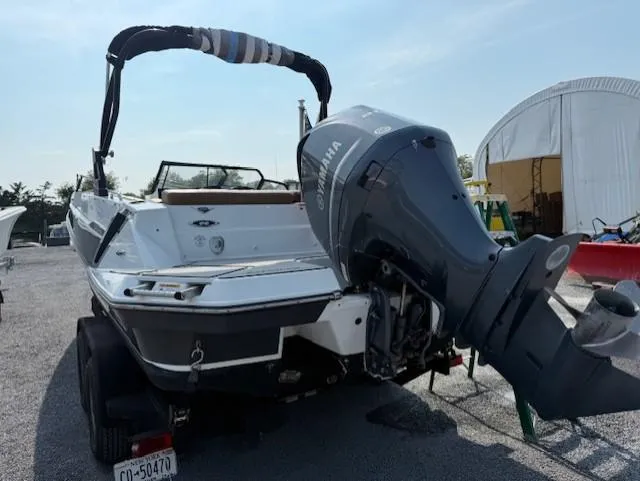 Slide: The Image of 2021 Glastron GTD 240 boat with Yamaha outboard motor, parked on a trailer. - 5