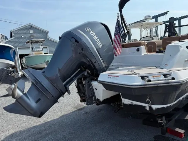 Slide: The Image of 2021 Glastron GTD 240 boat with Yamaha outboard motor, docked in a marina. - 6