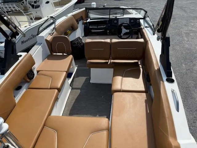 Slide: The Image of 2021 Glastron GTD 240 boat interior with tan seating and modern dashboard. - 7