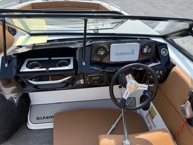 Slide: The Image of 2021 Glastron GTD 240 boat dashboard with Garmin navigation system and steering wheel. - 8